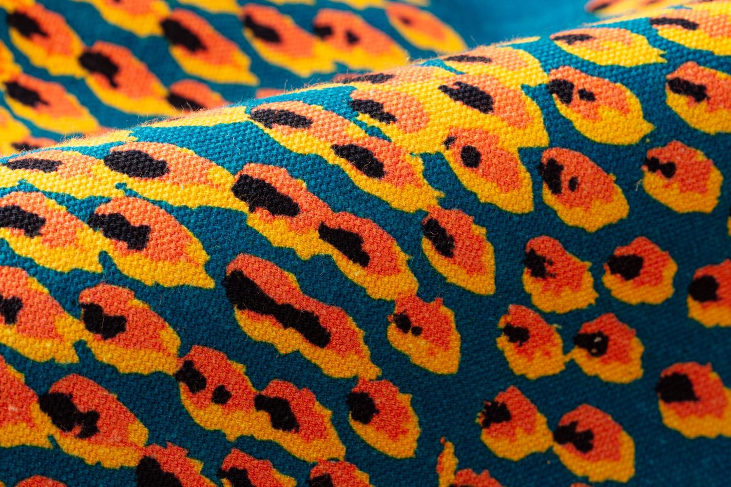 Close-up detail of Pilot Flame fabric showing energetic flame texture