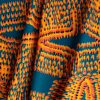 Pilot Flame fabric displaying scaled-up flame-like marks in orange on cotton-linen