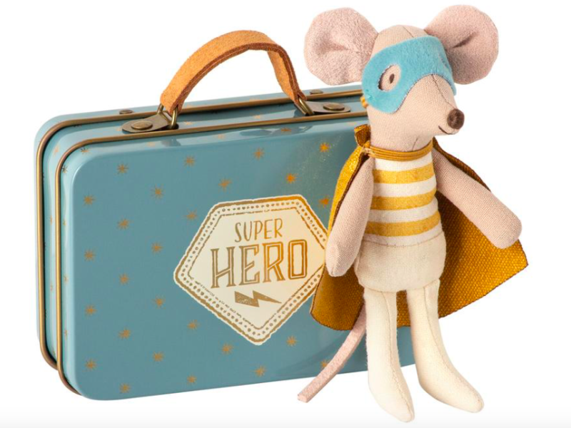 Little brother superhero in suitcase