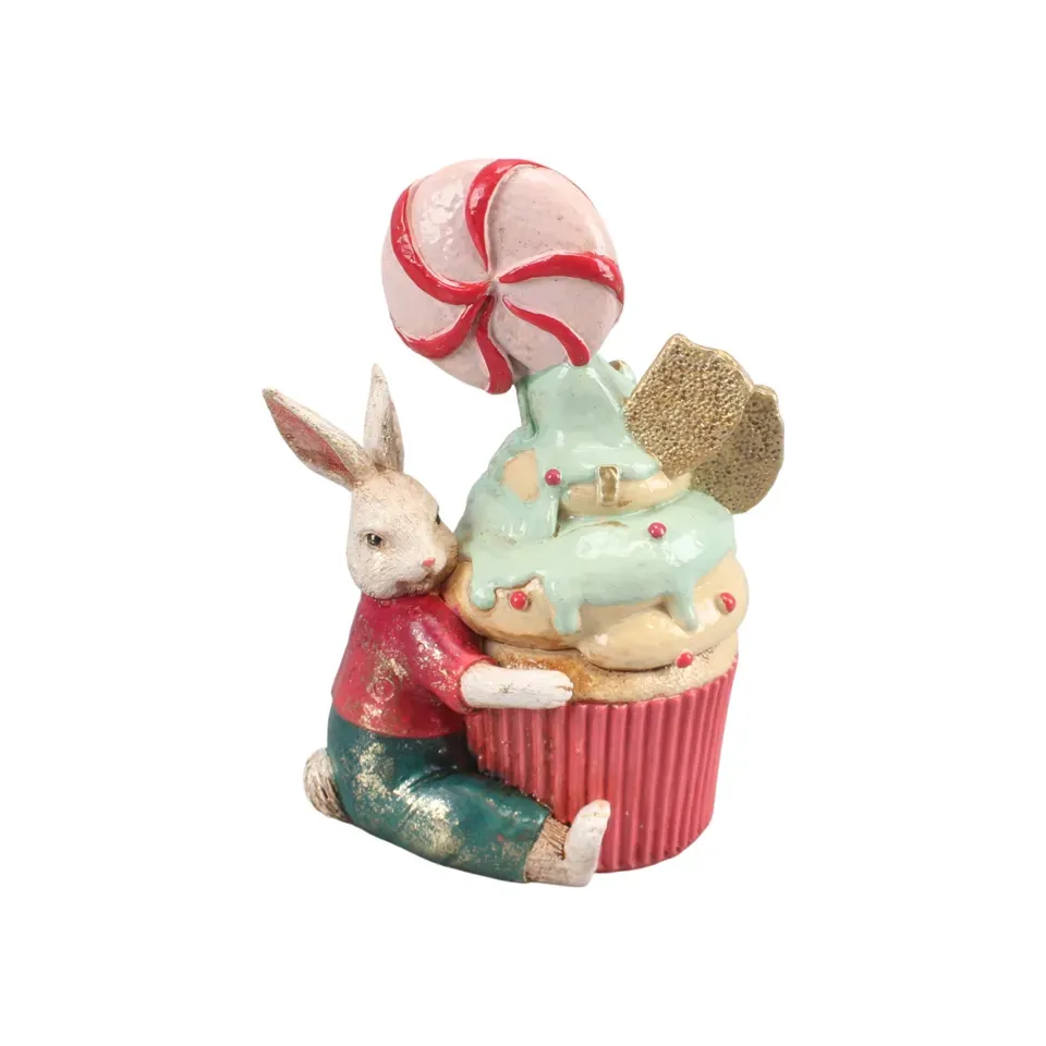 Kleiner Hase mit grossem pastellfarbenen Muffin, 20 cm, aus Kunstharz Kleiner Hase aus Kunstharz, 20 cm, der einen grossen pastellfarbenen Muffin umarmt