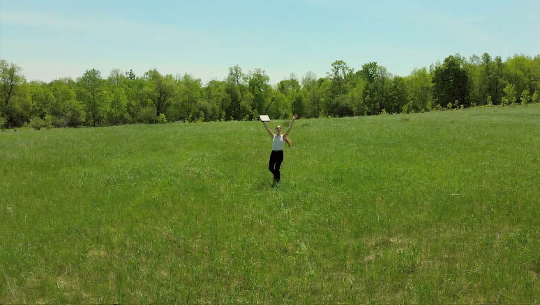 Young Woman Spins on Sunny Field holding office book twice, Hurray! (5) Young Woman Spins on Sunny Field holding office book twice, Hurray! (5)