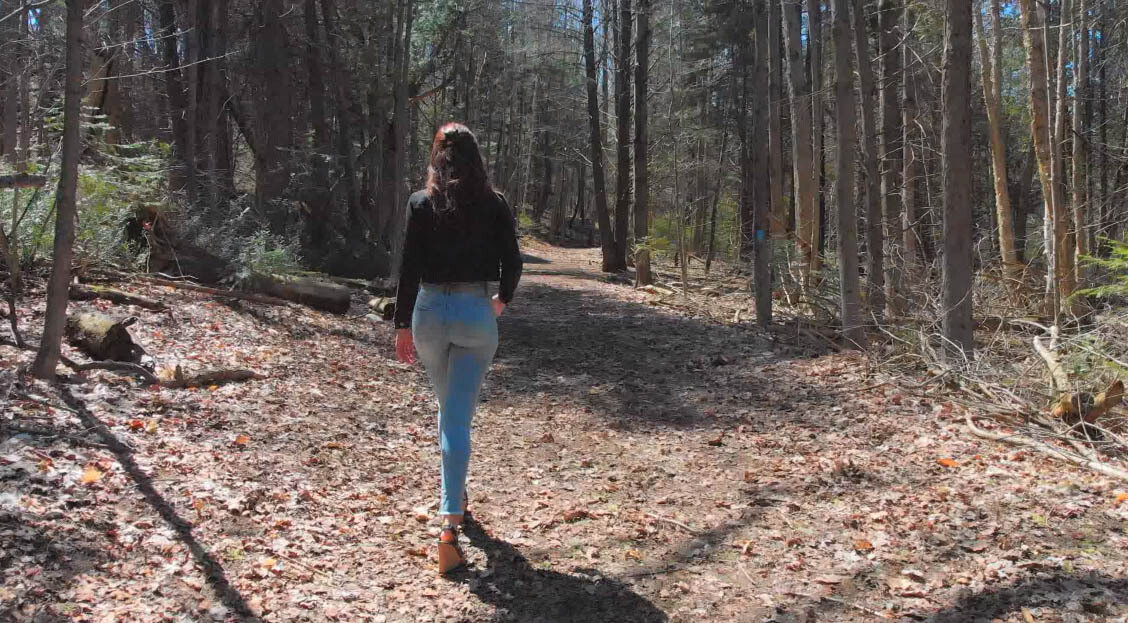 Woman Walking on Forest Path Woman Walking on Forest Path