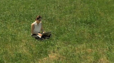 Woman Typing in Field