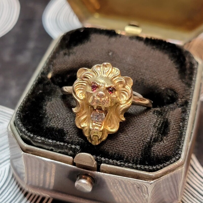 Lions Head Ring made of 14k Gold with Garnet Eyes and A Diamond in it's mouth.