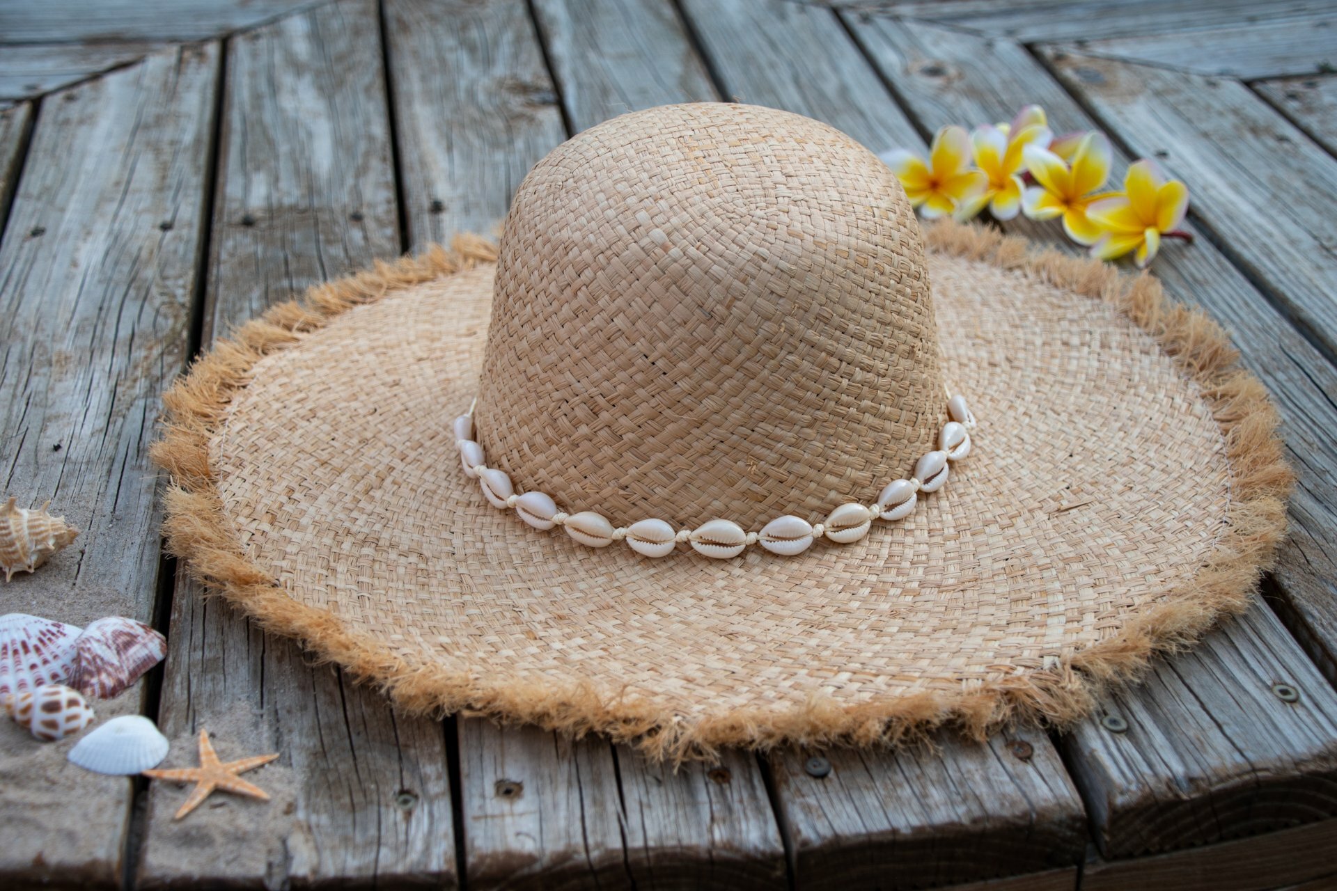 Raffia beach hat with white cowrie shells and white cord band. Free postage within Australia