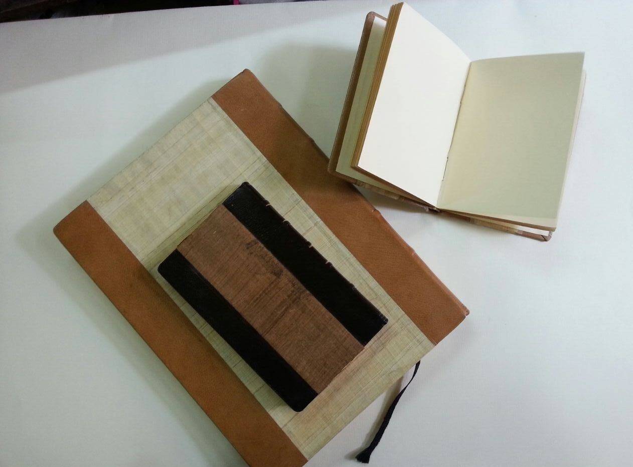Leather/papyrus covered blank paper journal .