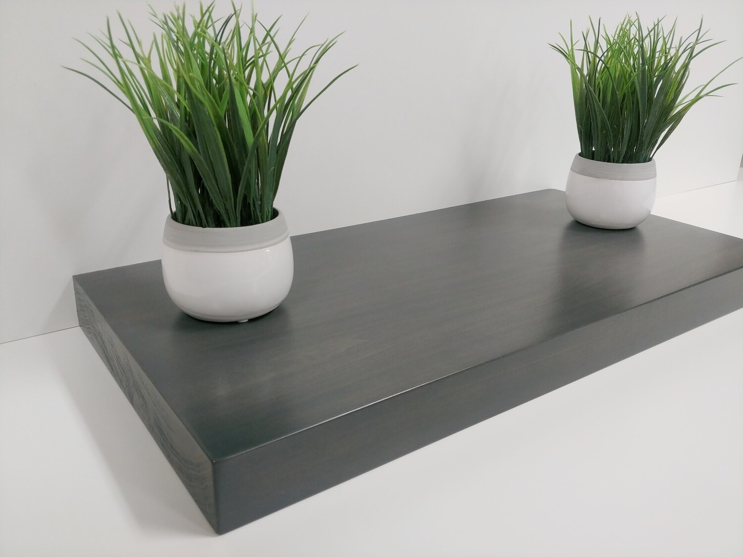 Dark charcoal floating shelf, 100% solid wood, includes hidden bracket
