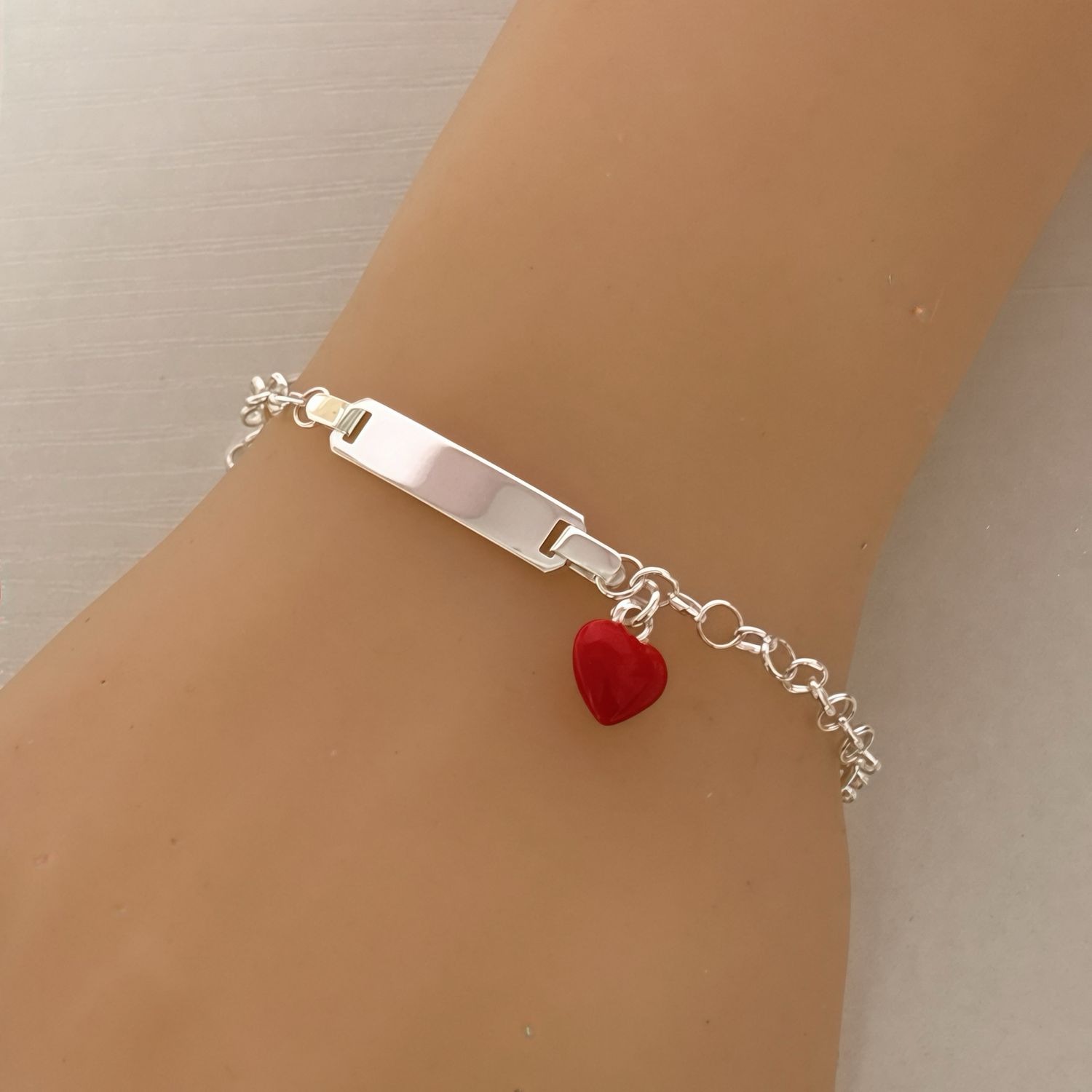 Bracelet with plaque and enamel puffed heart, measures 6" long, in Italian 925 Silver.