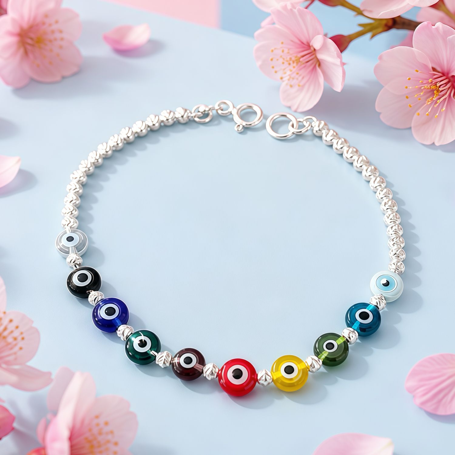 Pulsera  Ojitos colores mide 7" de largo, Plata 925 Mexicana.
