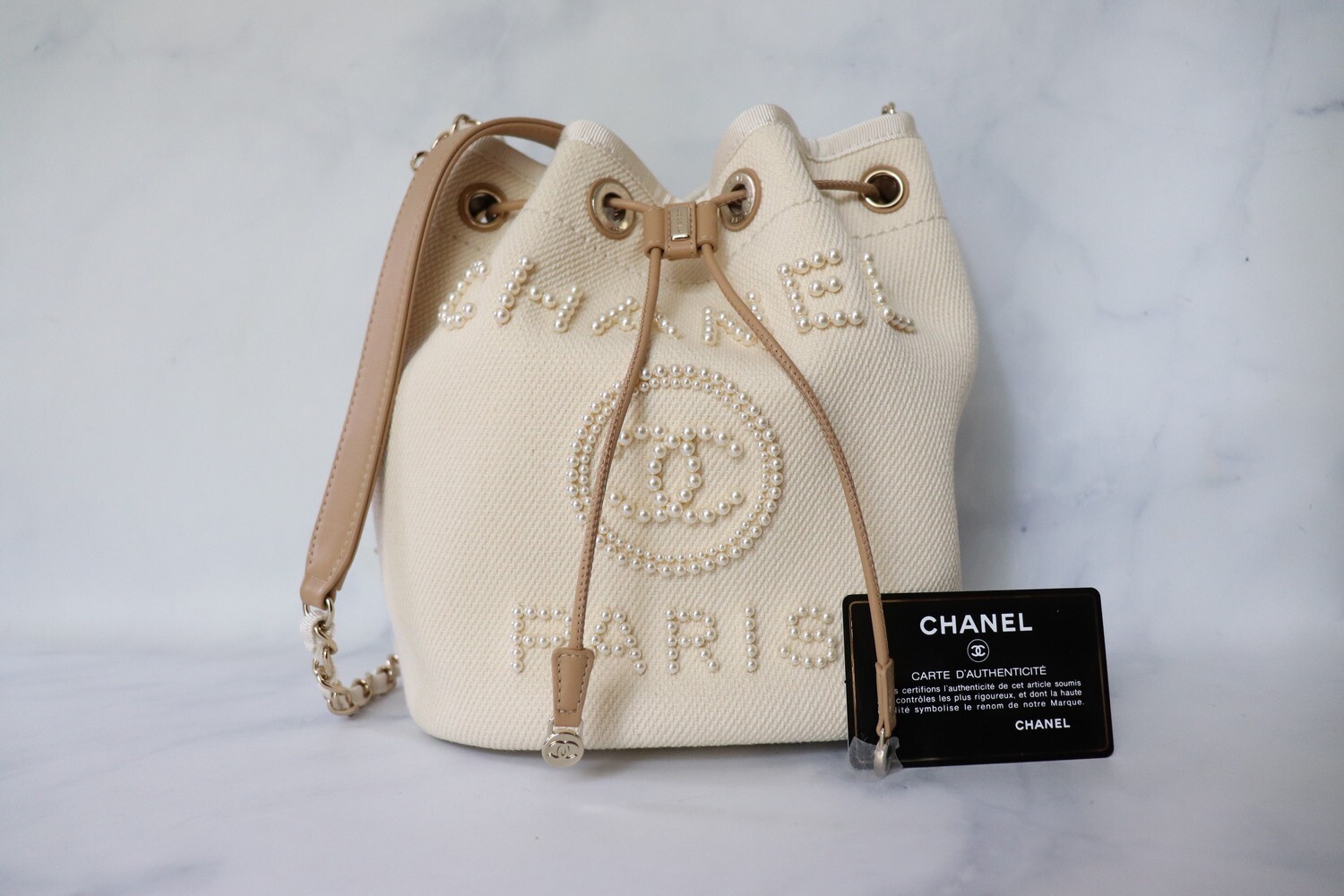 Chanel Light Beige Canvas Pearl Deauville Bucket Bag - Yoogi's Closet