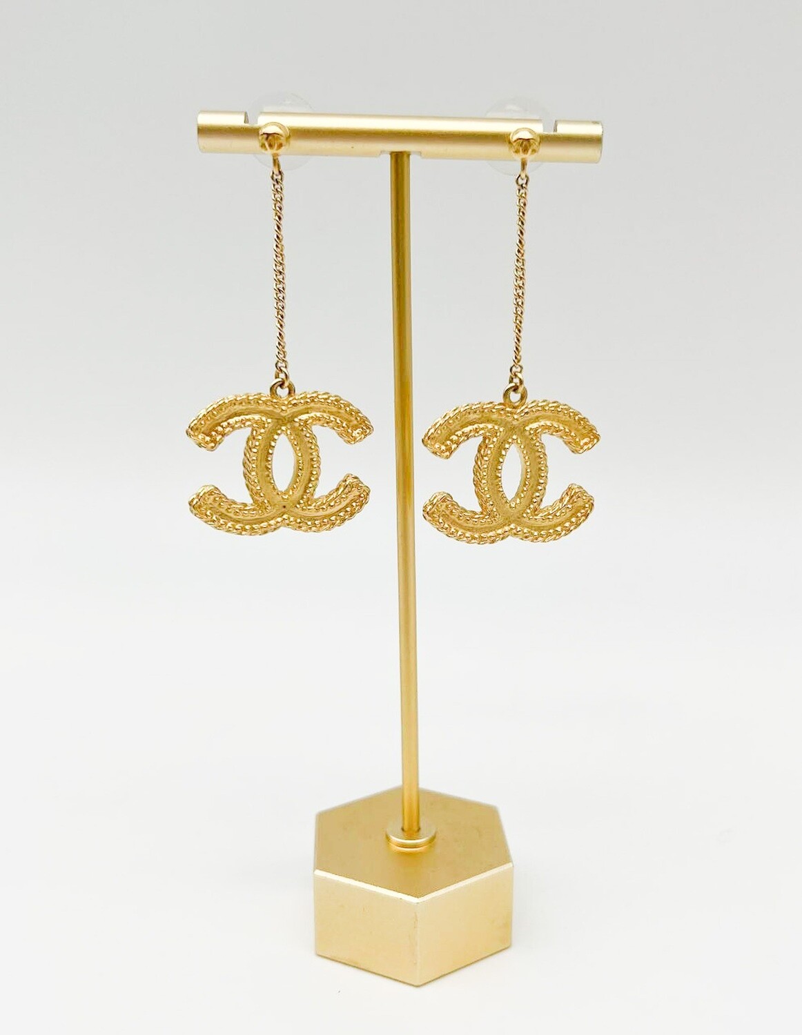 gold chanel earrings on ear