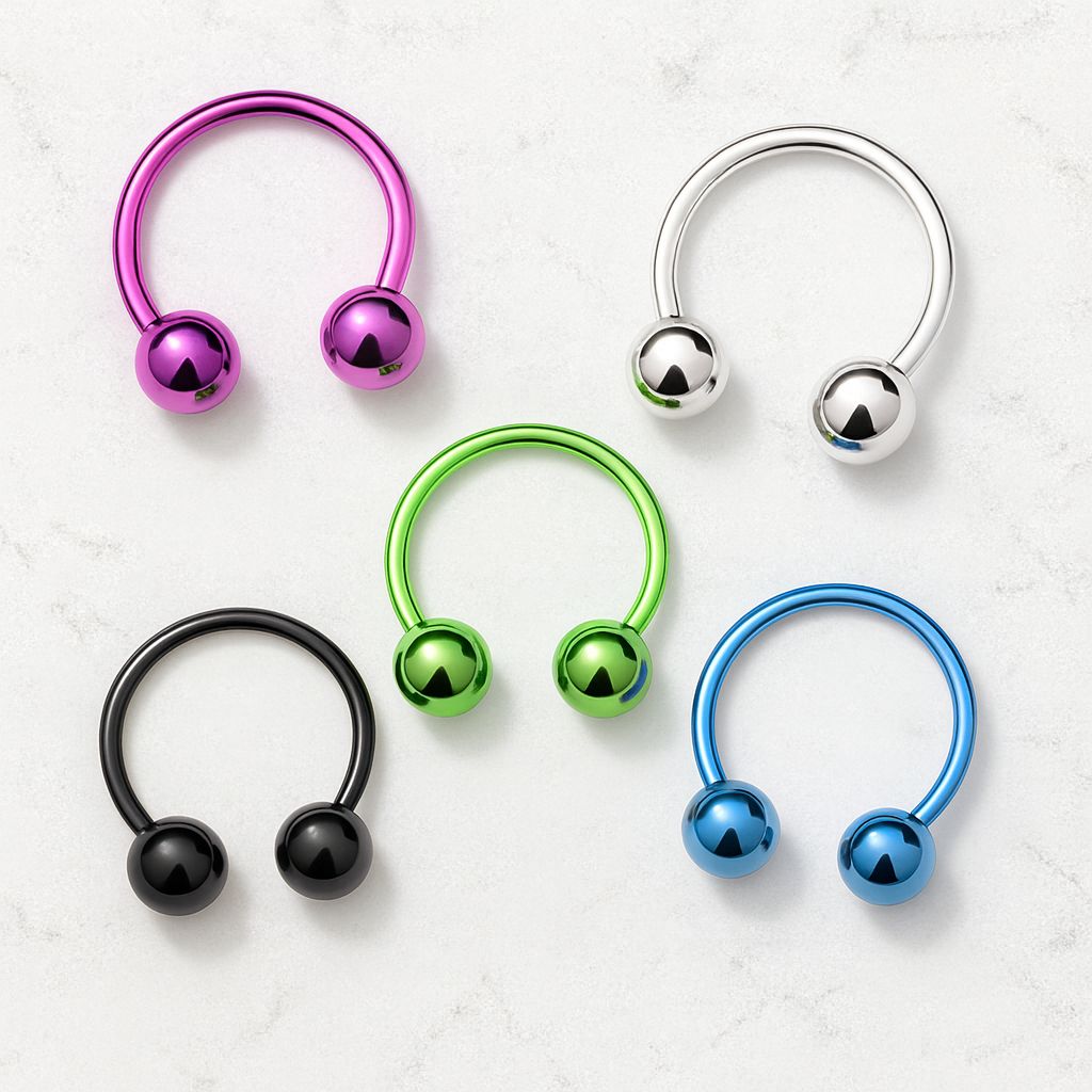 Five 16G horseshoe barbells in silver, purple, blue, green, and black displayed on a white granite background
