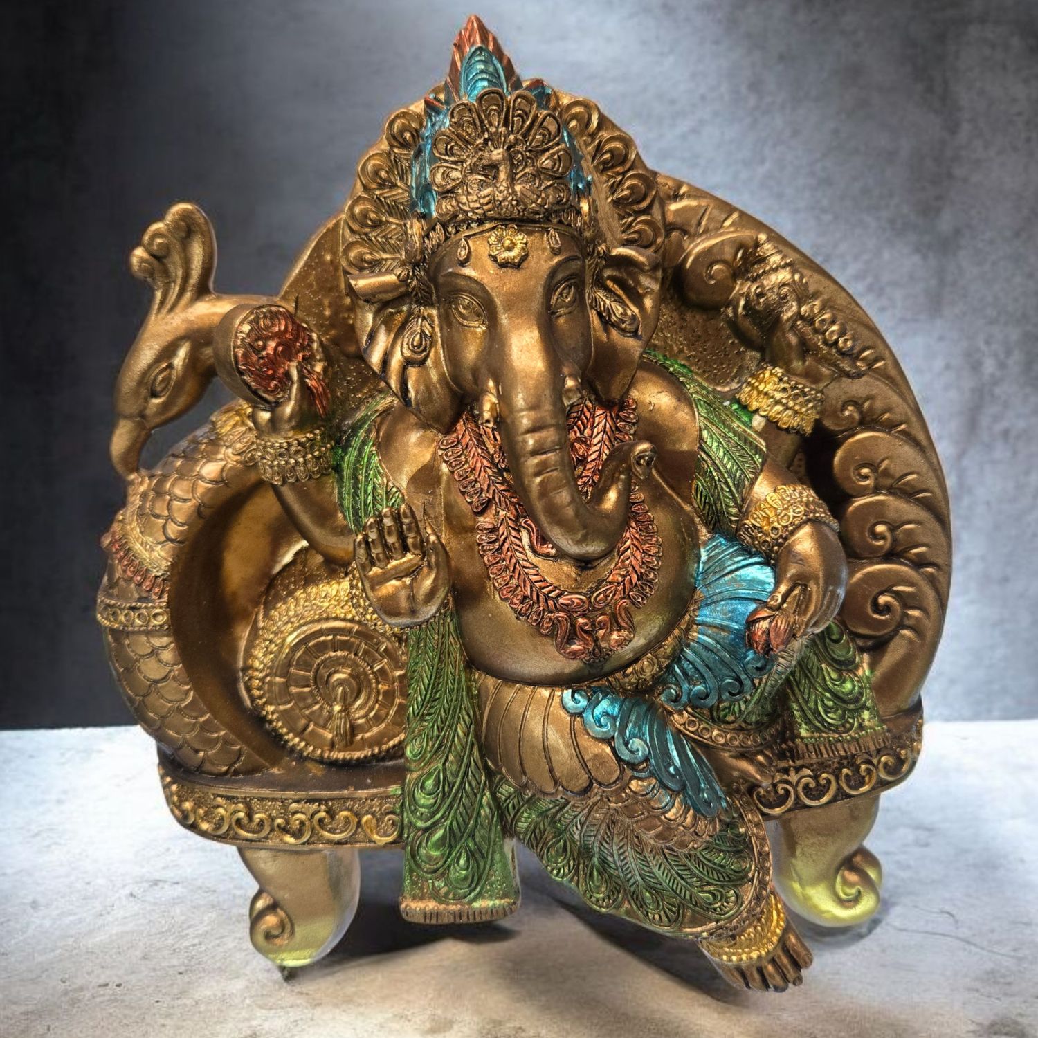 Hand-painted Ganesha seated on a colorful peacock throne, symbolizing wisdom, protection, and prosperity.