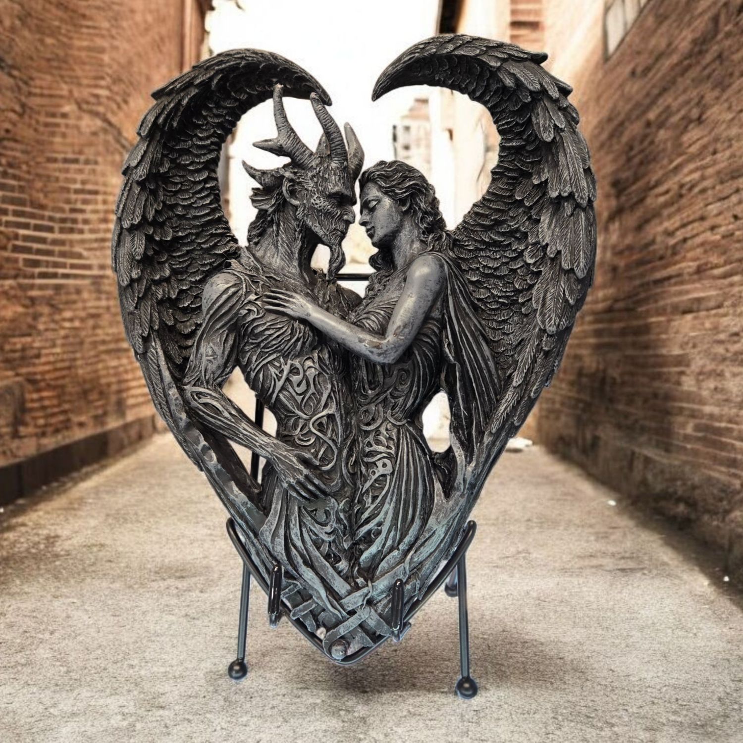 Angel and horned figure embracing in a heart-shaped wing design, hand-painted resin statue symbolizing unity and duality.
