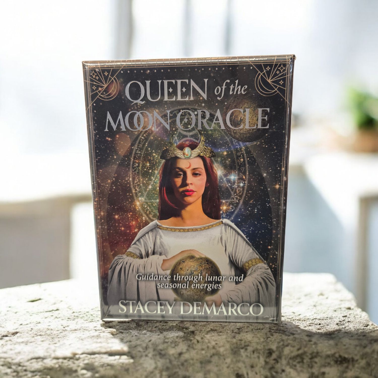 Queen of the Moon Oracle deck front showing lunar goddess artwork and celestial background by Stacey Demarco