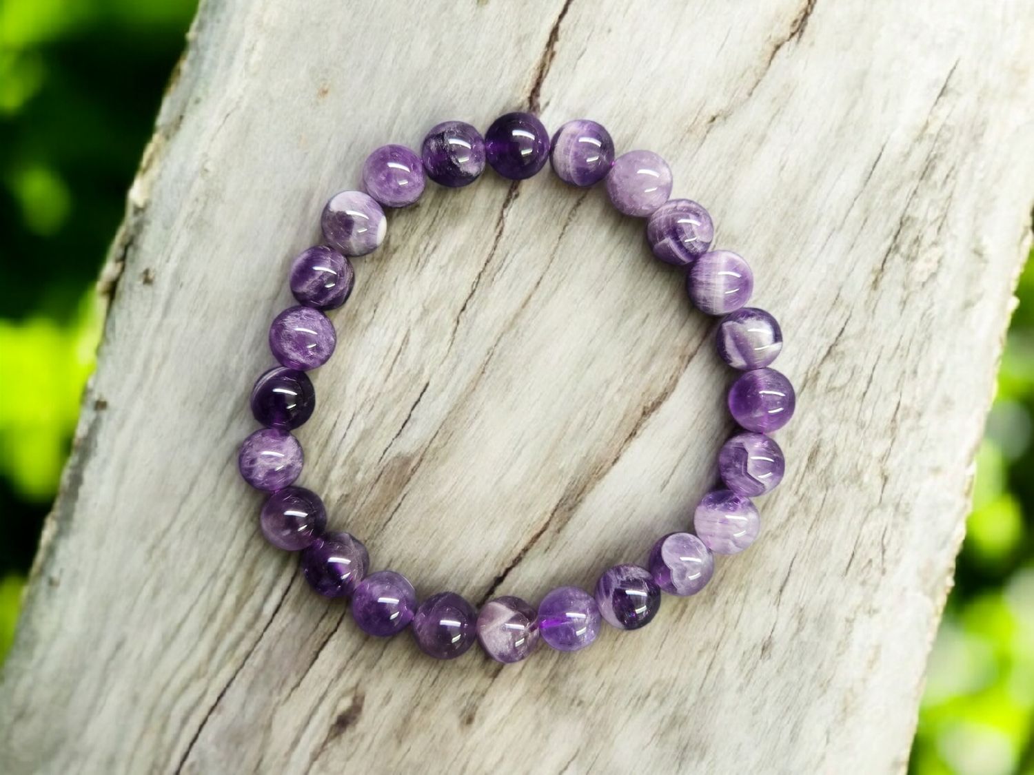 Chevron Amethyst 8mm round bead stretch bracelet displayed on textured wood background