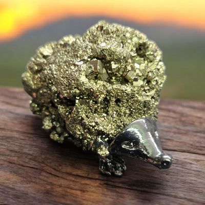 Pyrite hedgehog crystal carving with sparkling gold pyrite cluster and metal body