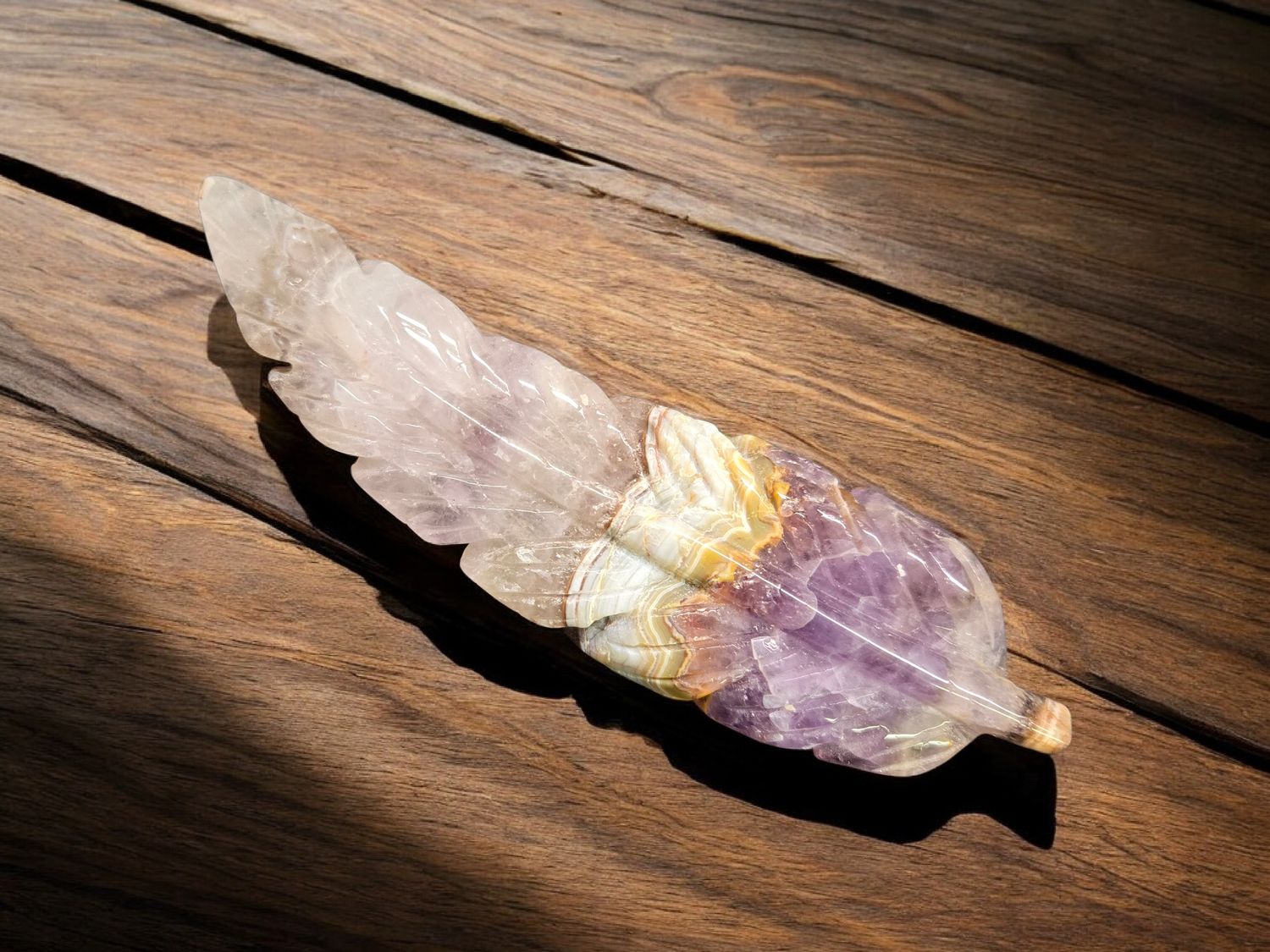 AMETHYST LACE AGATE FEATHER #7 Amethyst Lace Agate feather crystal carving with purple, cream, and lace banding, approx 6 inches long on wood surface