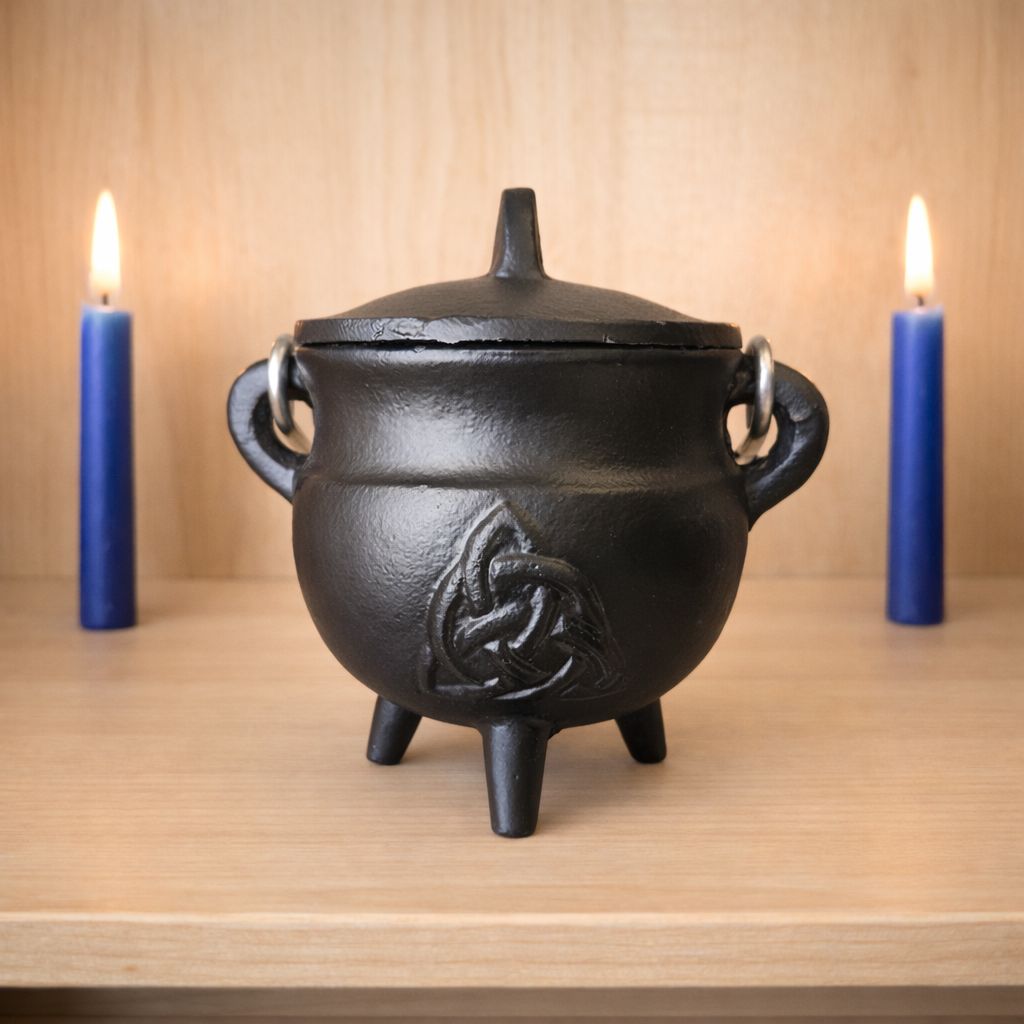 Small cast iron triquetra cauldron with lid on wooden altar with candles from Arkadys Metaphysical Gifts Amarillo TX