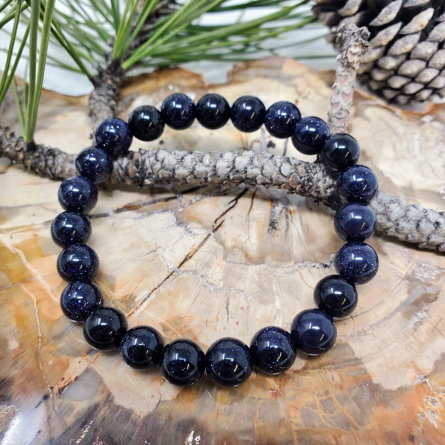 Blue goldstone 8mm stretch bracelet with deep blue beads and shimmering star-like flecks