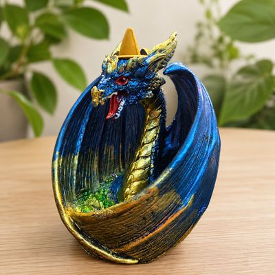 Dragon Wrap Wings LED Back Flow Burner on a wooden table.