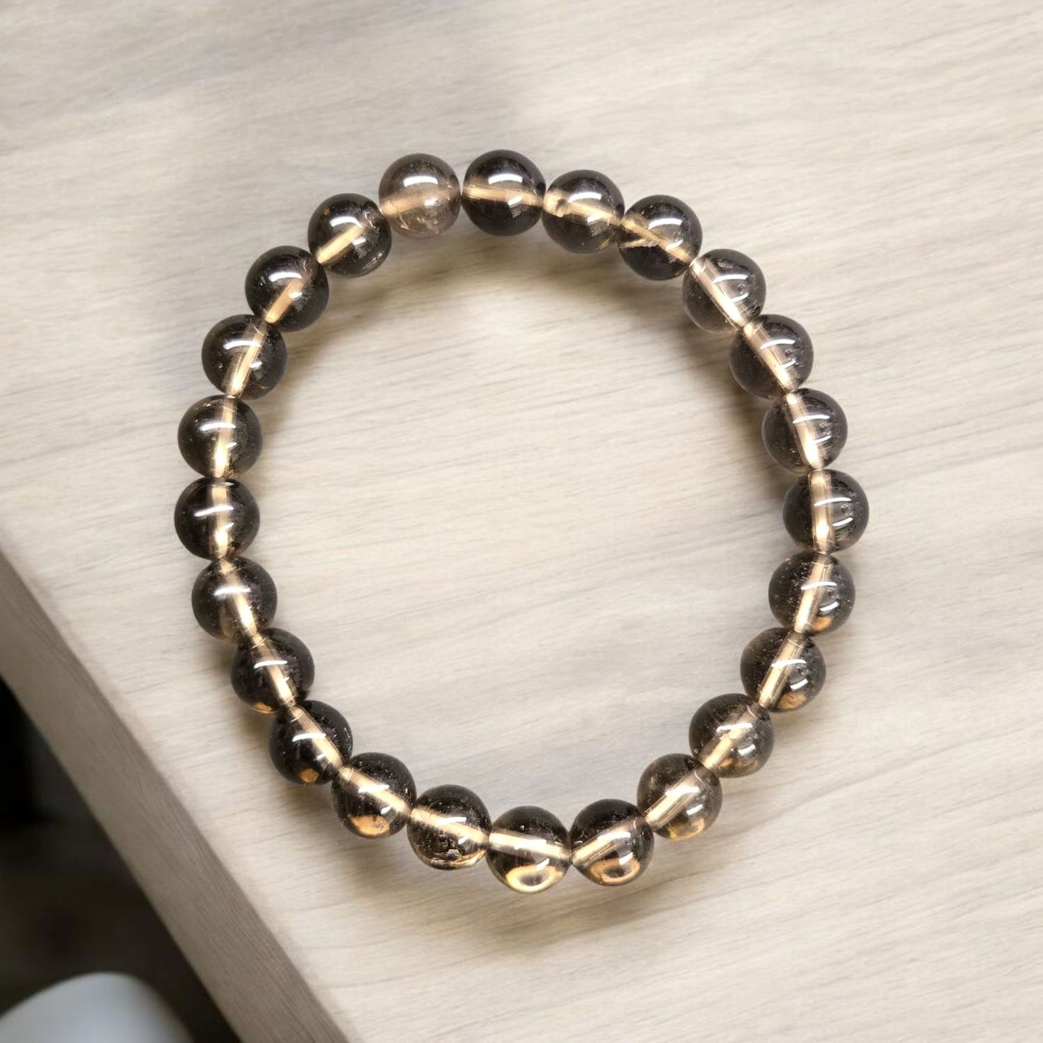 Smoky Quartz 8mm gemstone bracelet with polished translucent brown beads.