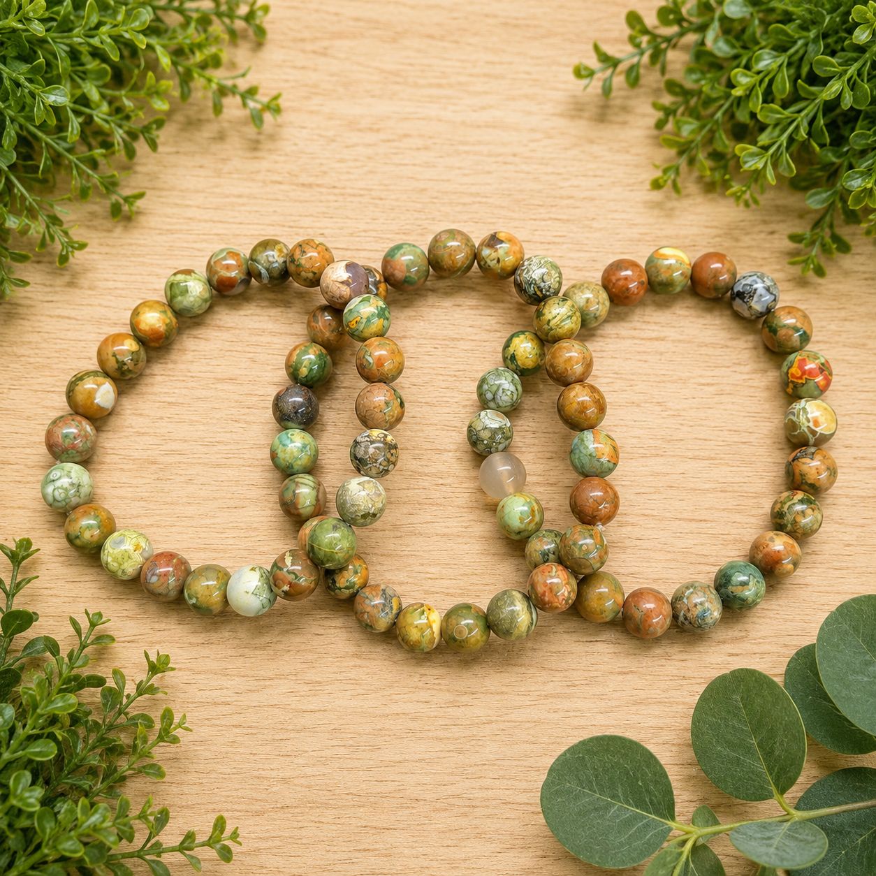 Multiple rainforest Jasper Rhyolite 8mm bracelets with polished green, brown, rust and cream beads.