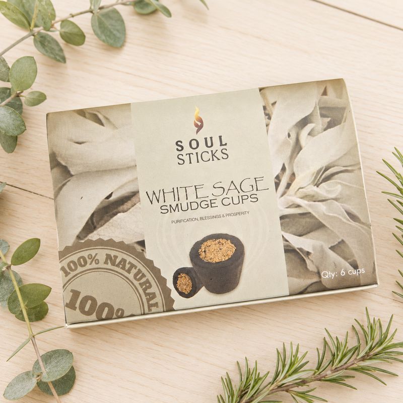 Soul Sticks White Sage Smudge Cups six-pack box displayed on a light wooden table with greenery.