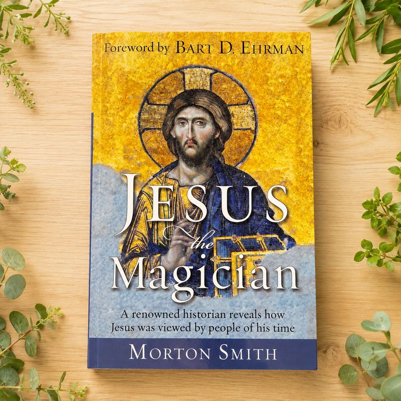 Jesus the Magician by Morton Smith displayed on a light wooden table with greenery.