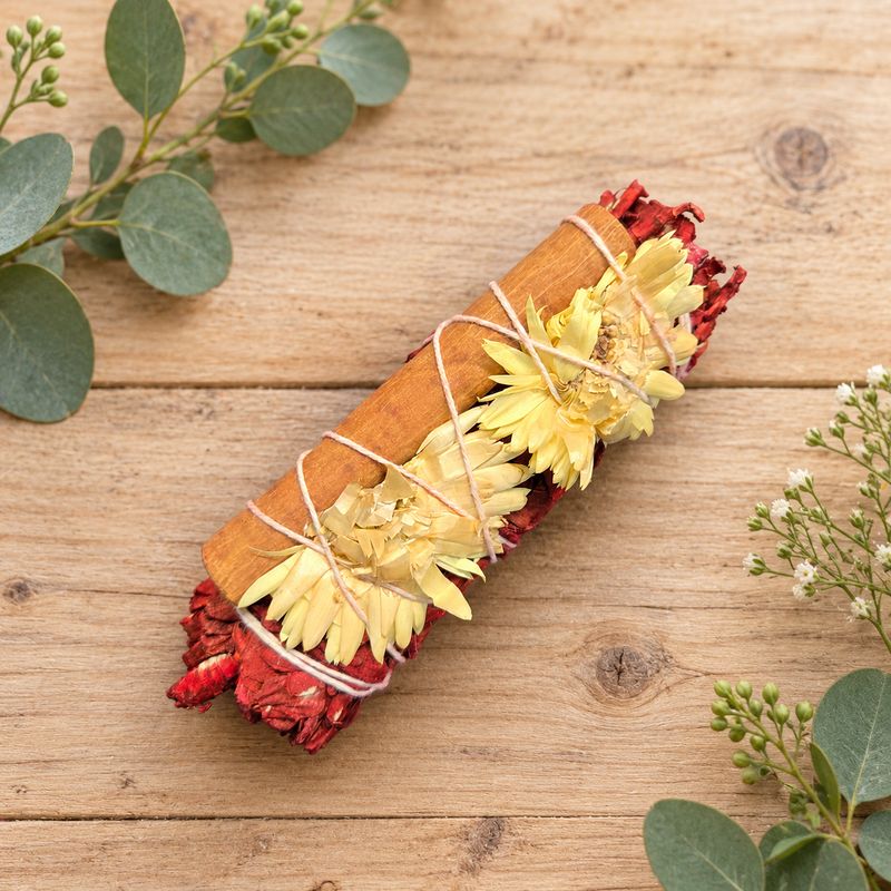 Dragon’s Blood protection and prosperity smudge with white sage, cinnamon and yellow flowers