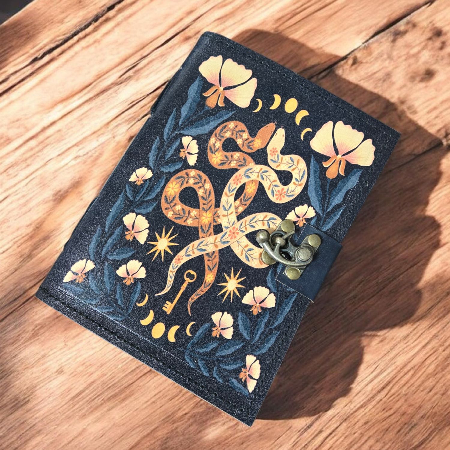 SNAKES OF WISDOM LEATHER JOURNAL W/LATCH Snakes of Wisdom leather journal with serpent artwork at Arkadys Metaphysical Gifts metaphysical shop in Amarillo Texas