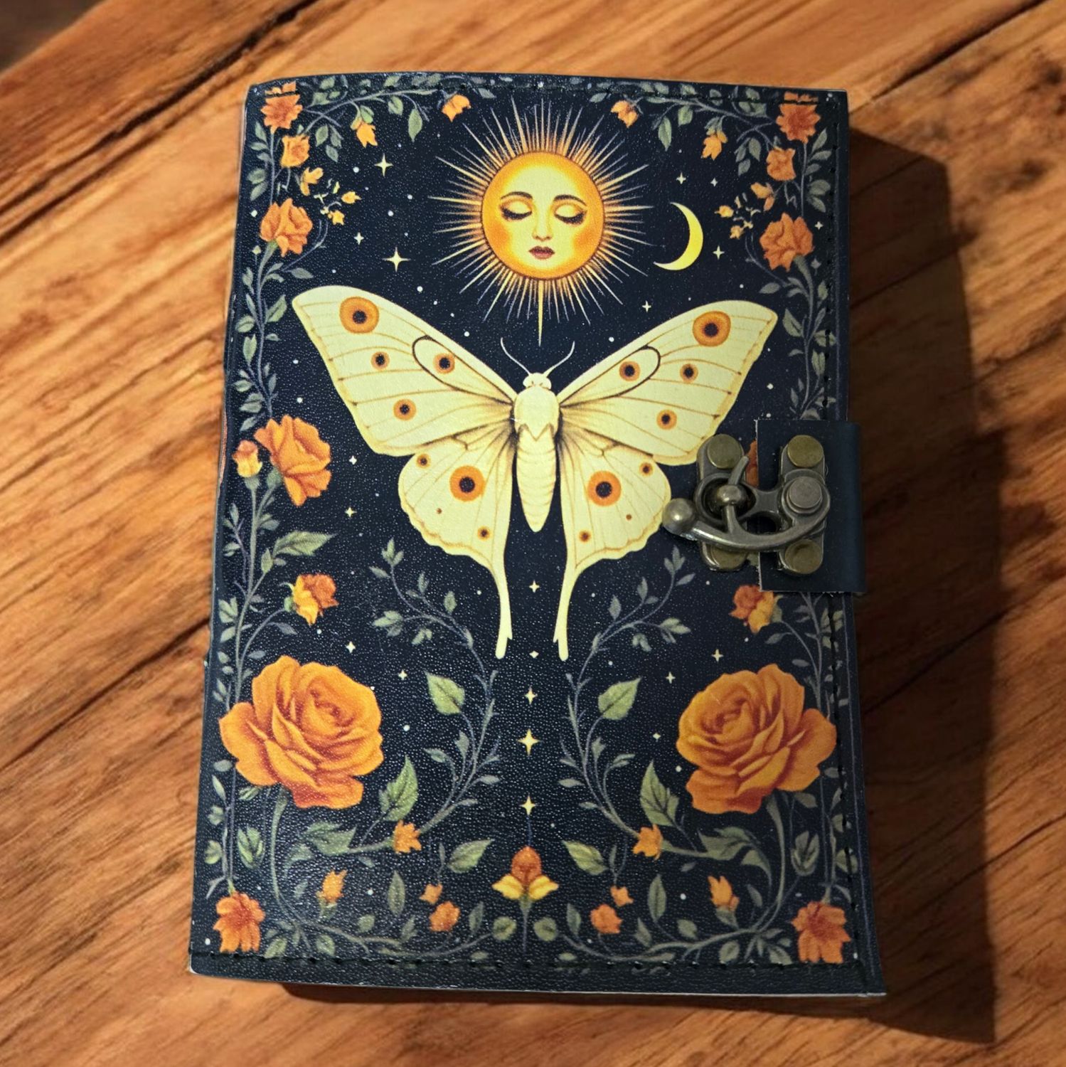 SOLAR MOTH LEATHER JOURNAL W/LATCH Solar moth leather journal with latch and celestial moth design at Arkadys Metaphysical Gifts metaphysical shop in Amarillo.