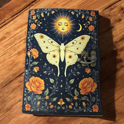 Solar moth leather journal with latch and celestial moth design at Arkadys Metaphysical Gifts metaphysical shop in Amarillo.