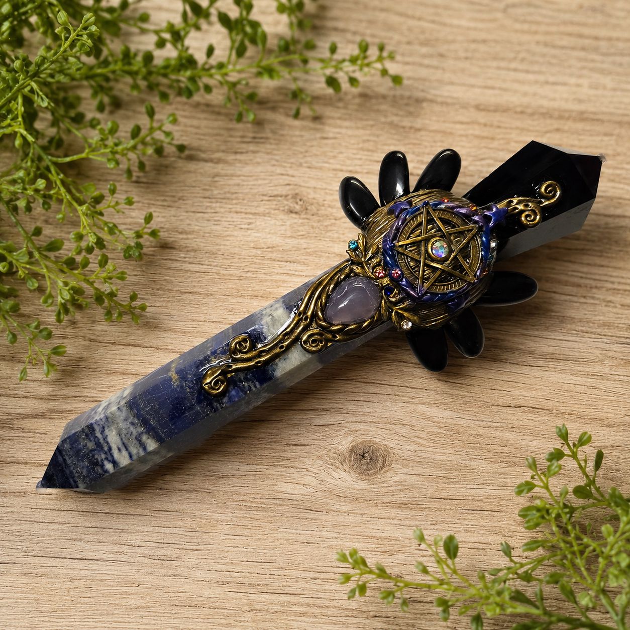 Black Obsidian and Lapis Lazuli Exquisite Point Athame with pentacle detail on a light wooden table with greenery.