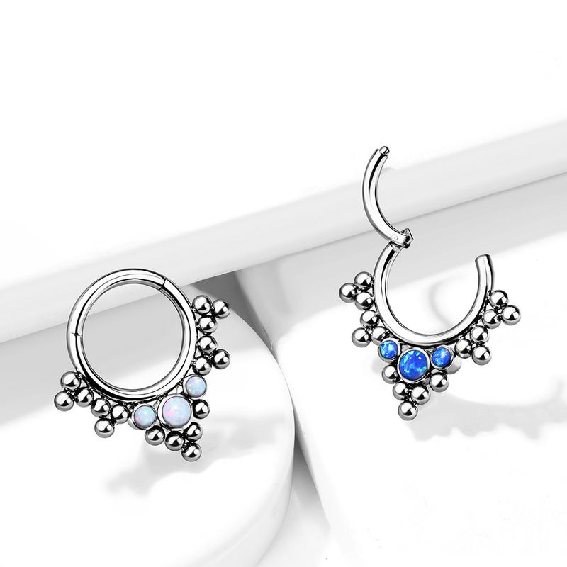 Implant grade titanium opal boho hinge segment rings in blue and white opal styles on display.