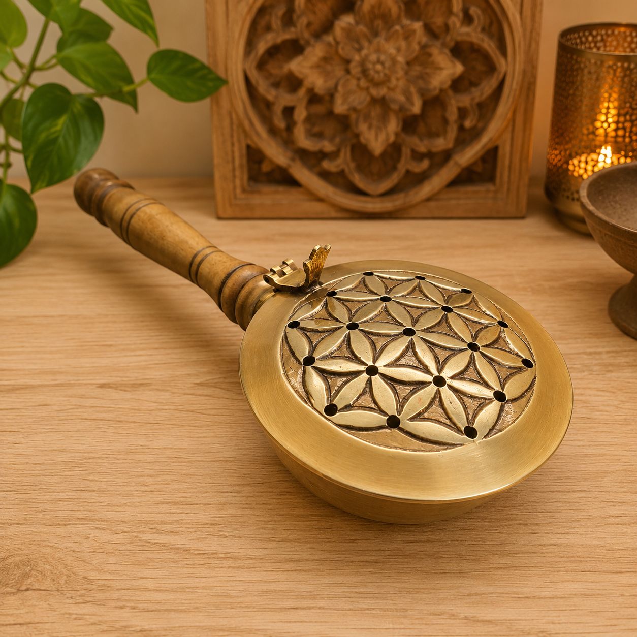 Flower of Life brass incense burner with wooden handle on altar table at Arkadys Metaphysical Gifts