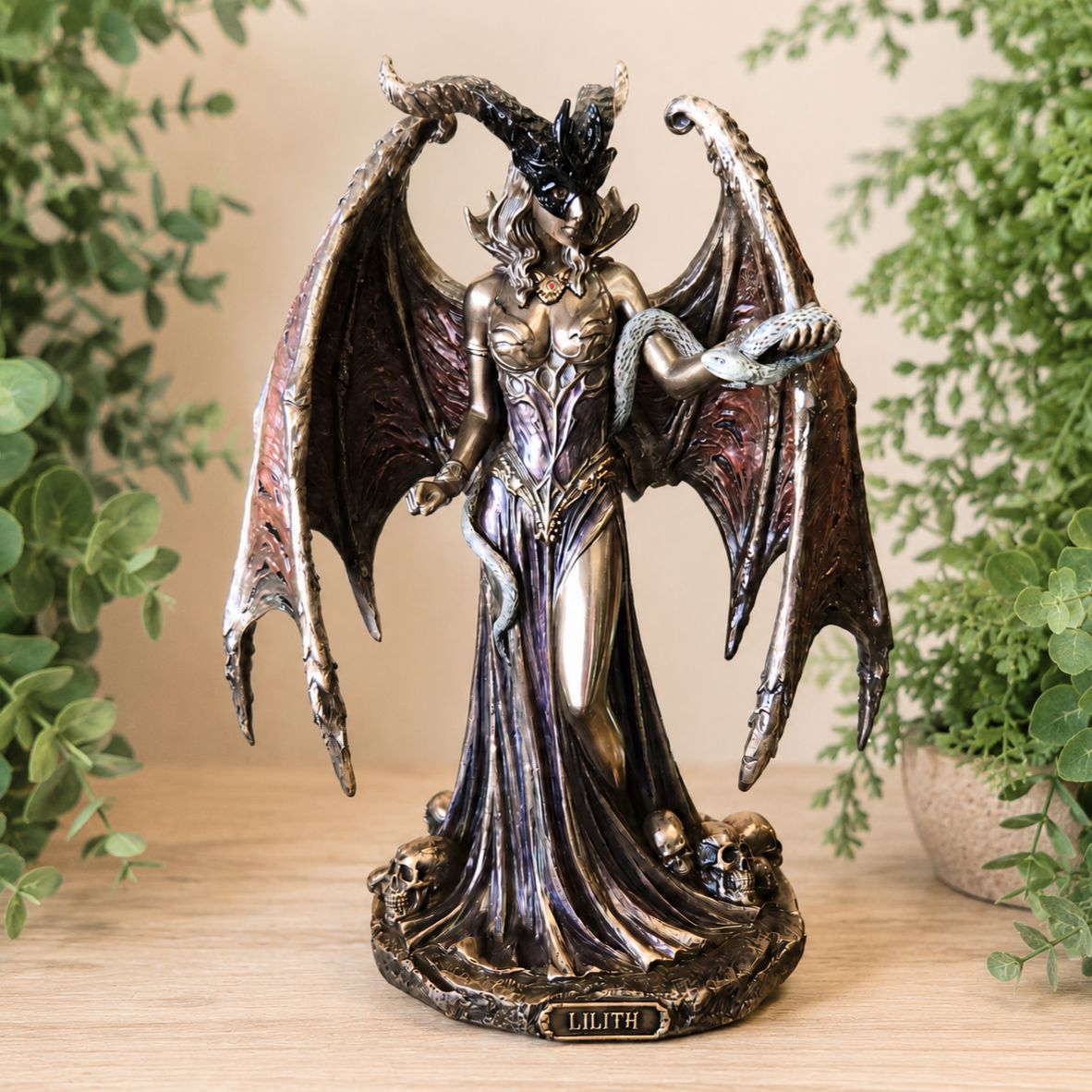 Front of Lilith The First Woman bronzed statue with wings and serpent detail.