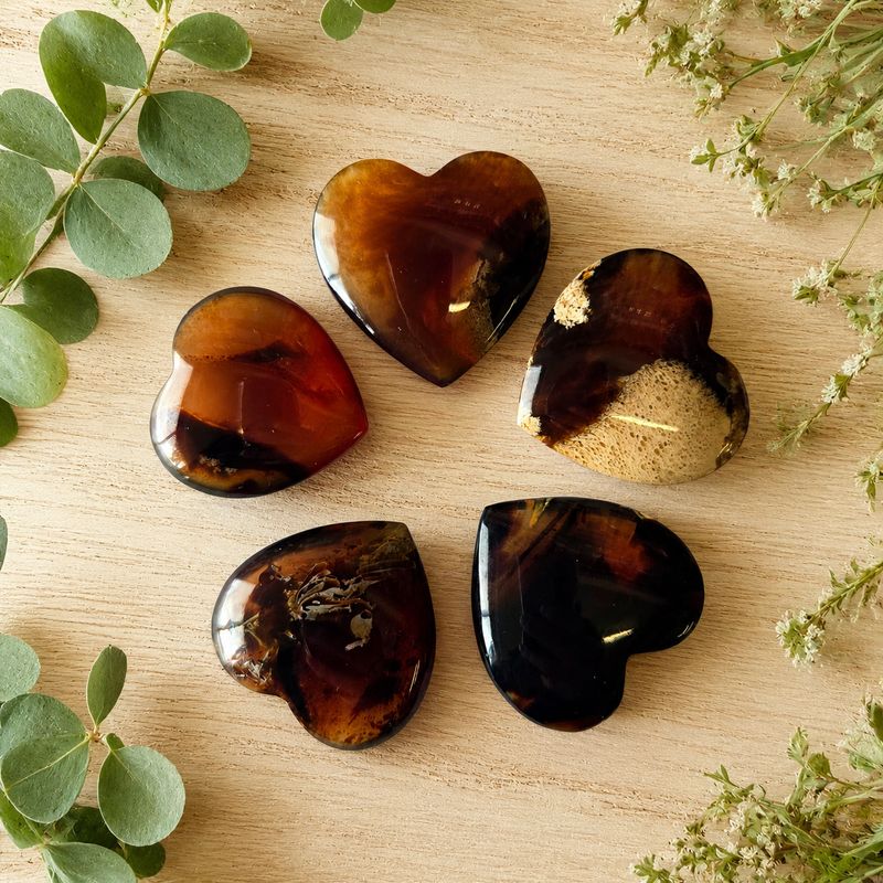 100 percent Natural Amber Mini Heart on light wooden table with greenery