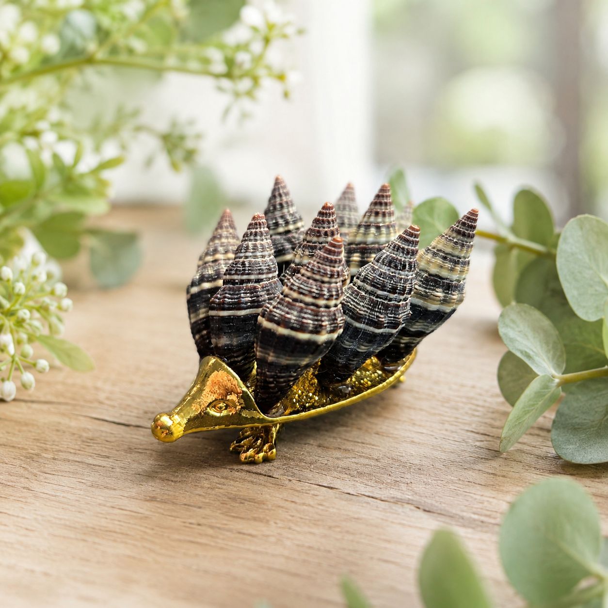 Shells hedgehog made with natural shells on gold-toned base