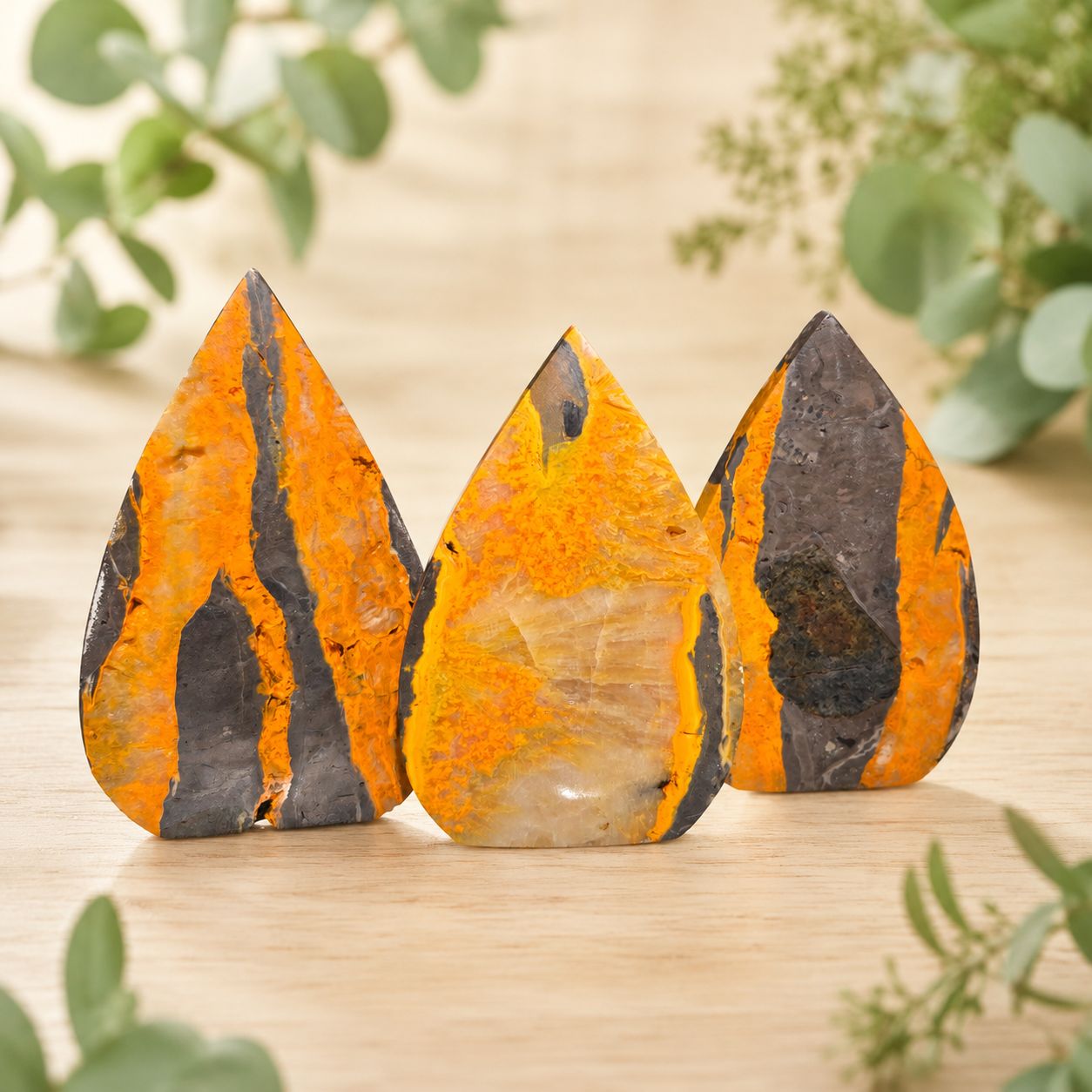 Large polished Bumblebee Jasper arrow shapes with vivid orange, yellow, cream and charcoal gray natural patterns.