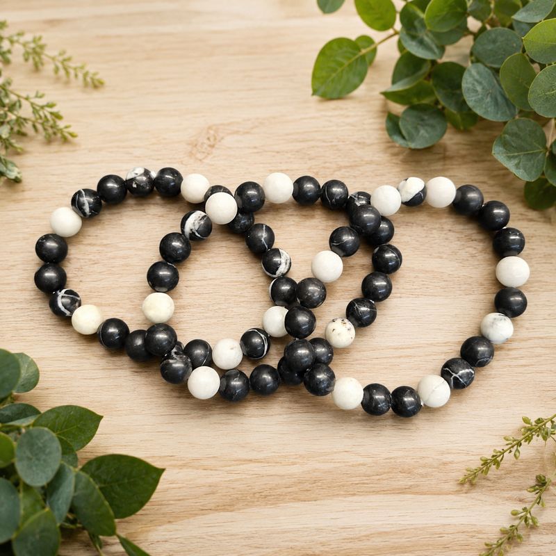 Multiple zebra Jasper 8mm bracelets with polished black, white and marbled beads on stretch cord.