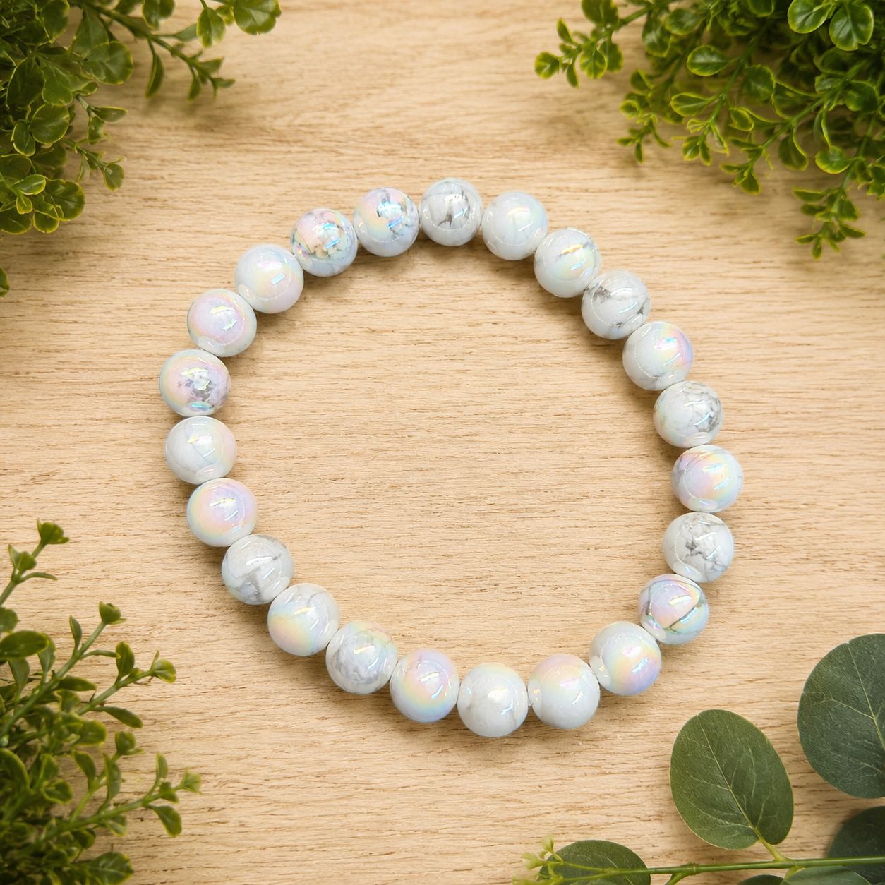 Angel Aura Howlite 8mm bracelet with white veined beads and an iridescent rainbow finish.