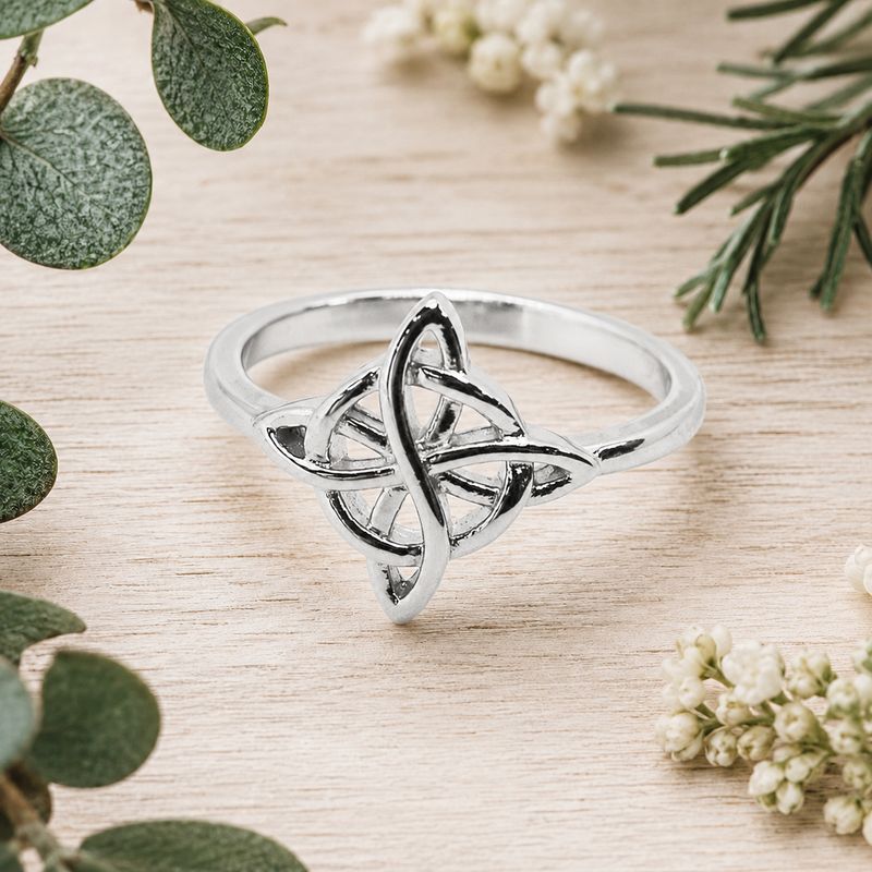 925 sterling silver Witch’s Knot ring with polished interwoven design displayed on a light wooden table
