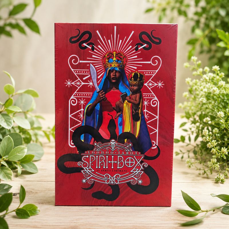 Front of Voodoo Tarot Spirit Box Kit by Fabio Listrani displayed on a light wooden table with greenery