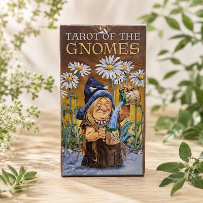 Front of Tarot of the Gnomes 78-card deck featuring a gnome pouring a drink among tall daisies