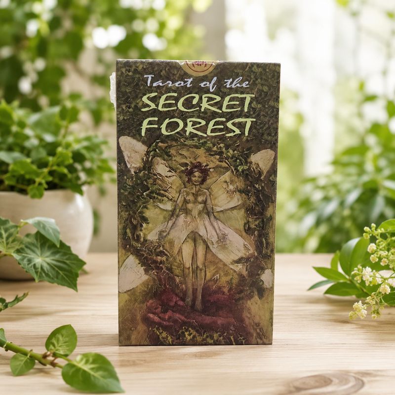 Front of Tarot of the Secret Forest deck featuring a fairy surrounded by woodland greenery