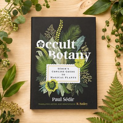 Occult Botany by Paul Sédir displayed on a light wooden table surrounded by greenery.