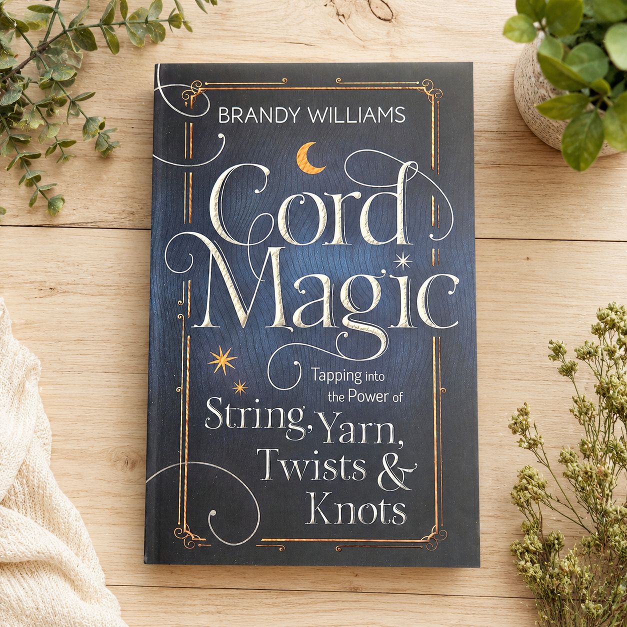 Cord Magic by Brandy Williams displayed on a light wooden table with greenery.