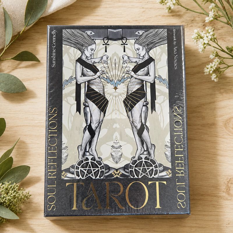 Soul Reflections Tarot deck displayed on a light wooden table with greenery.