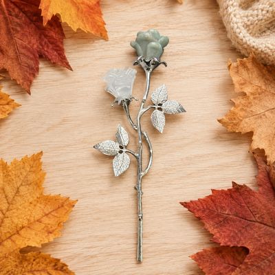 Quartz and Amazonite rose pair on silver-tone stems with textured leaves on a light wooden table